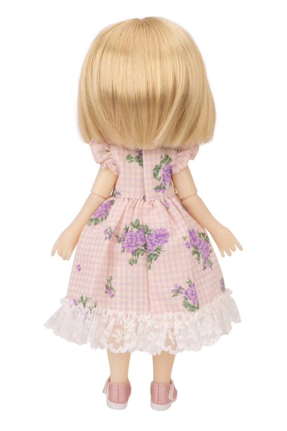 Doll wearing a pink floral dress on a white background