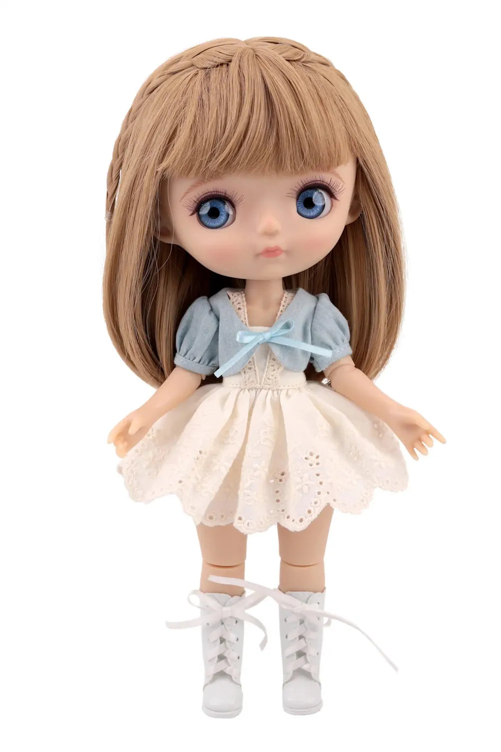 Mori Lolli doll wearing a light blue blouse, white lace skirt, and white lace-up boots.