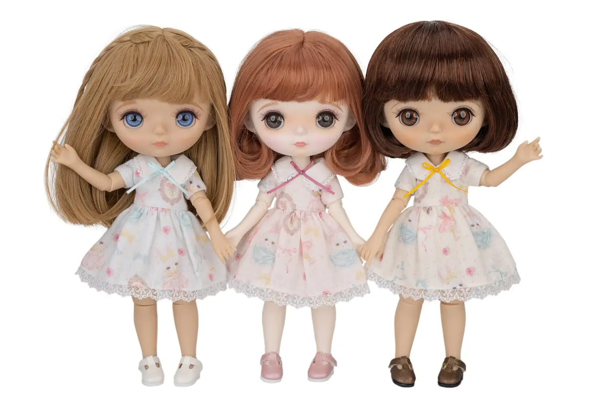 Three dolls with different hairstyles and outfits on a white background