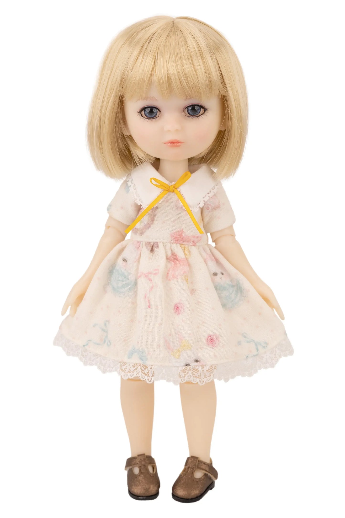 Doll with blonde hair and a floral dress on a white background
