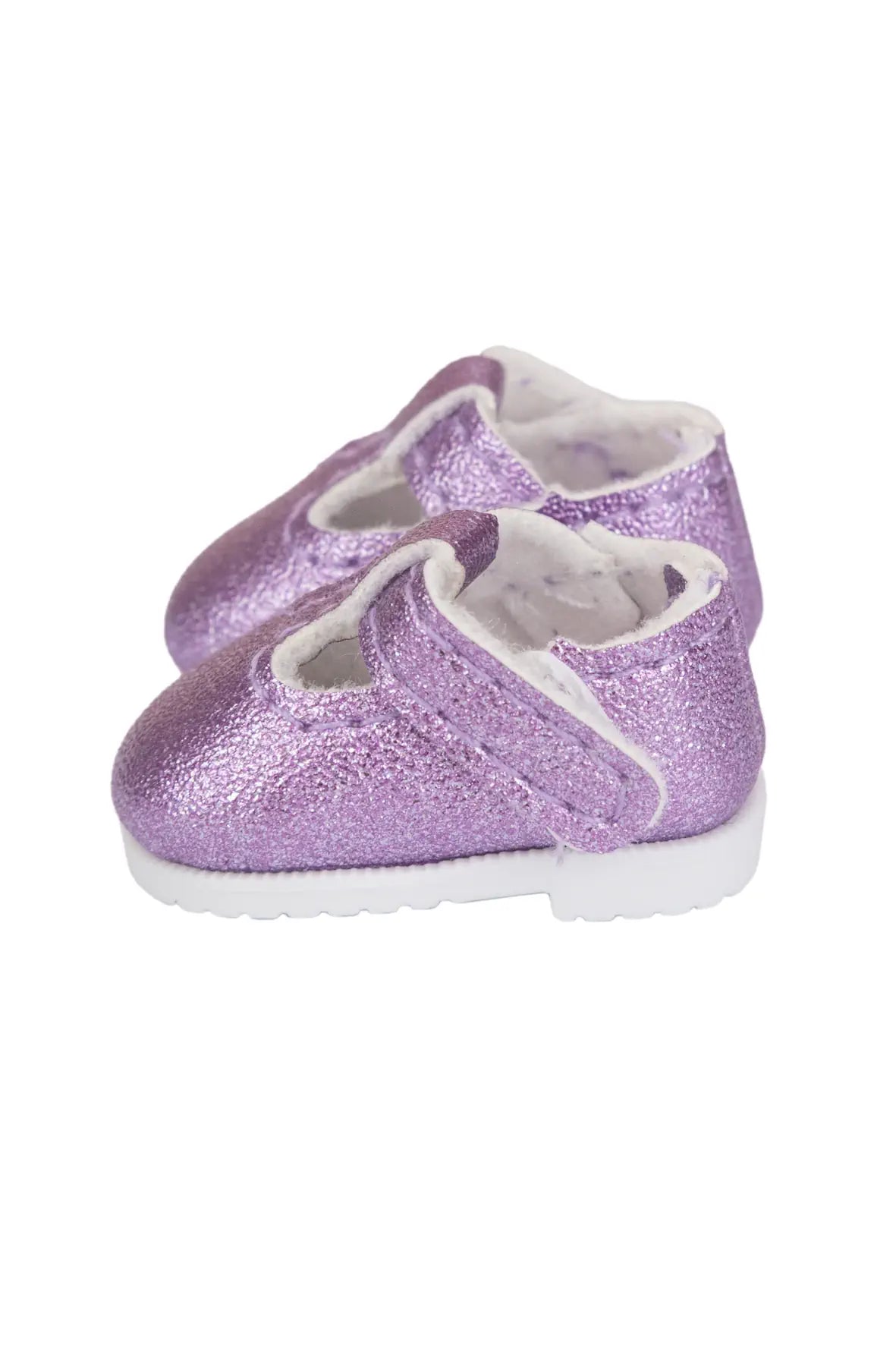 A pair of small glittery lavender-purple doll shoes with white soles and white fuzzy lining, shown on a plain white background.
