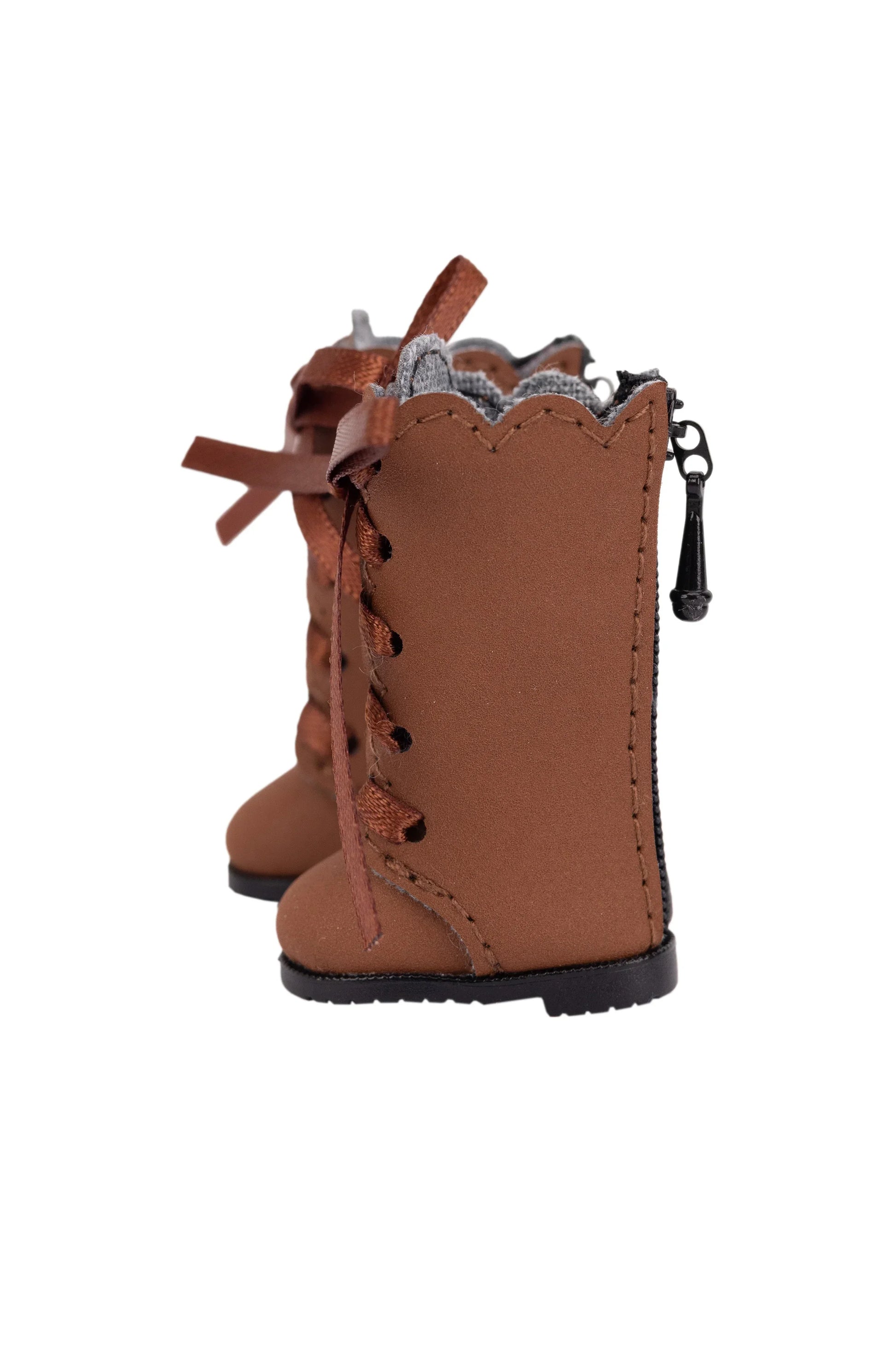 Brown boot with lace-up design and decorative bow on a white background