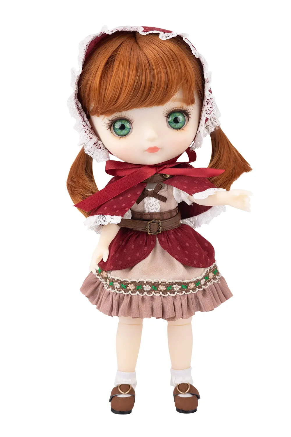 Doll with ginger hair and traditional outfit on a white background