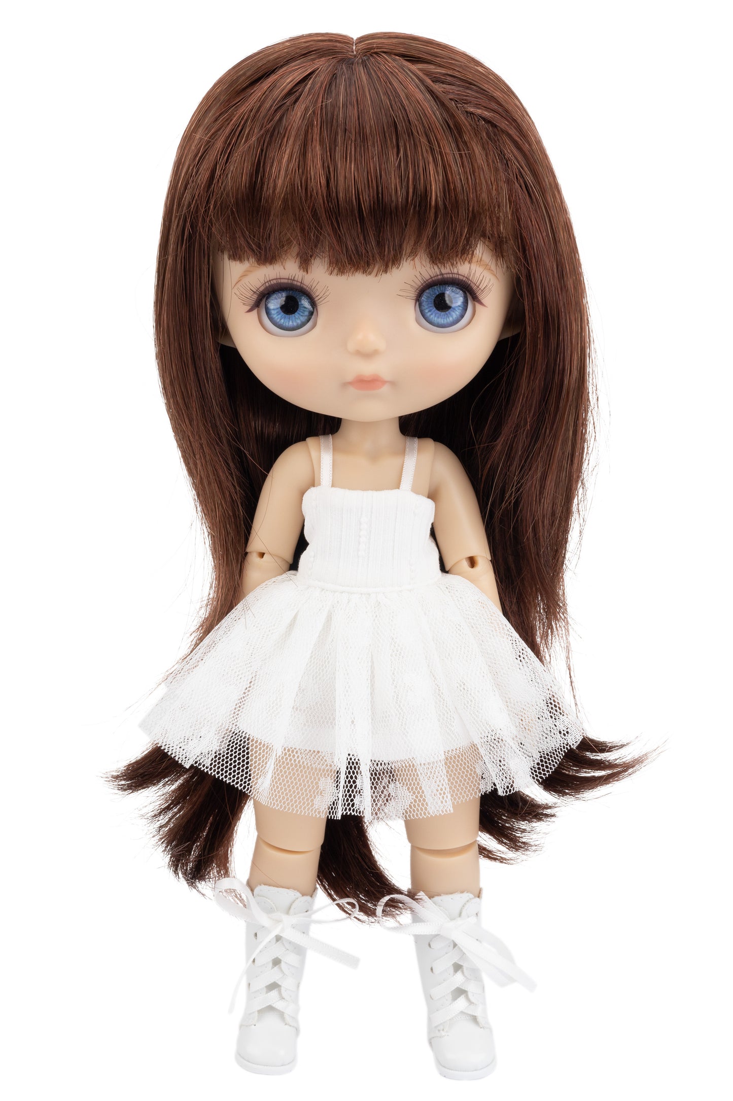 Doll with long brown hair and blue eyes wearing a white dress on a white background