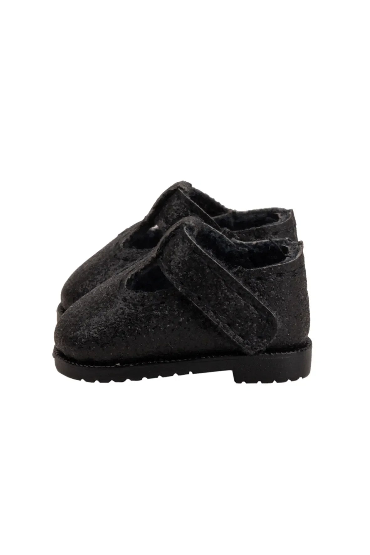 Black shoe with a strap on a white background