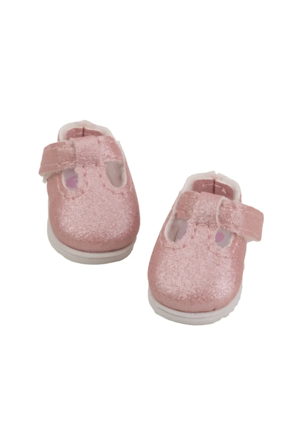 Pair of pink doll shoes on a white background