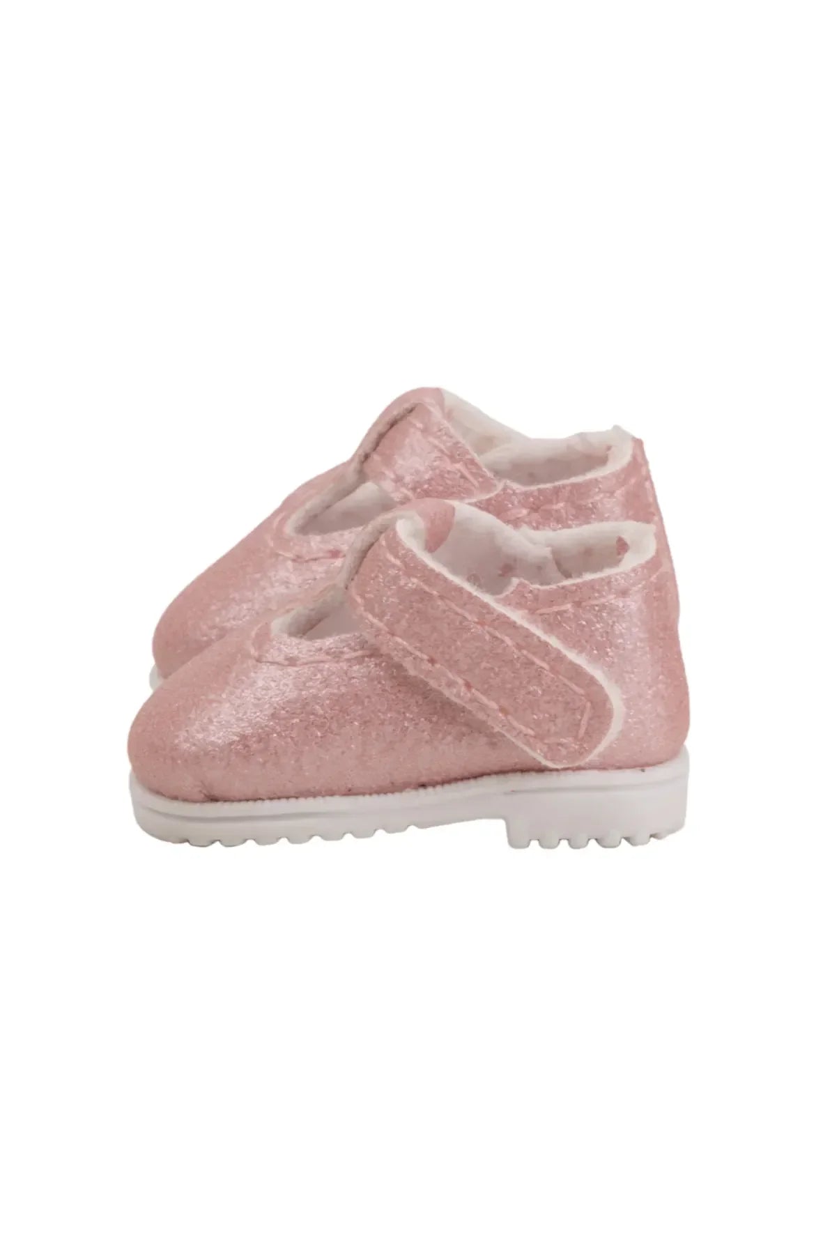 Pink glittery doll shoe on a white background