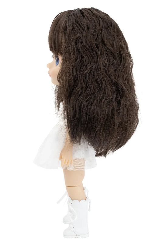 Doll with long dark brown hair on a white background