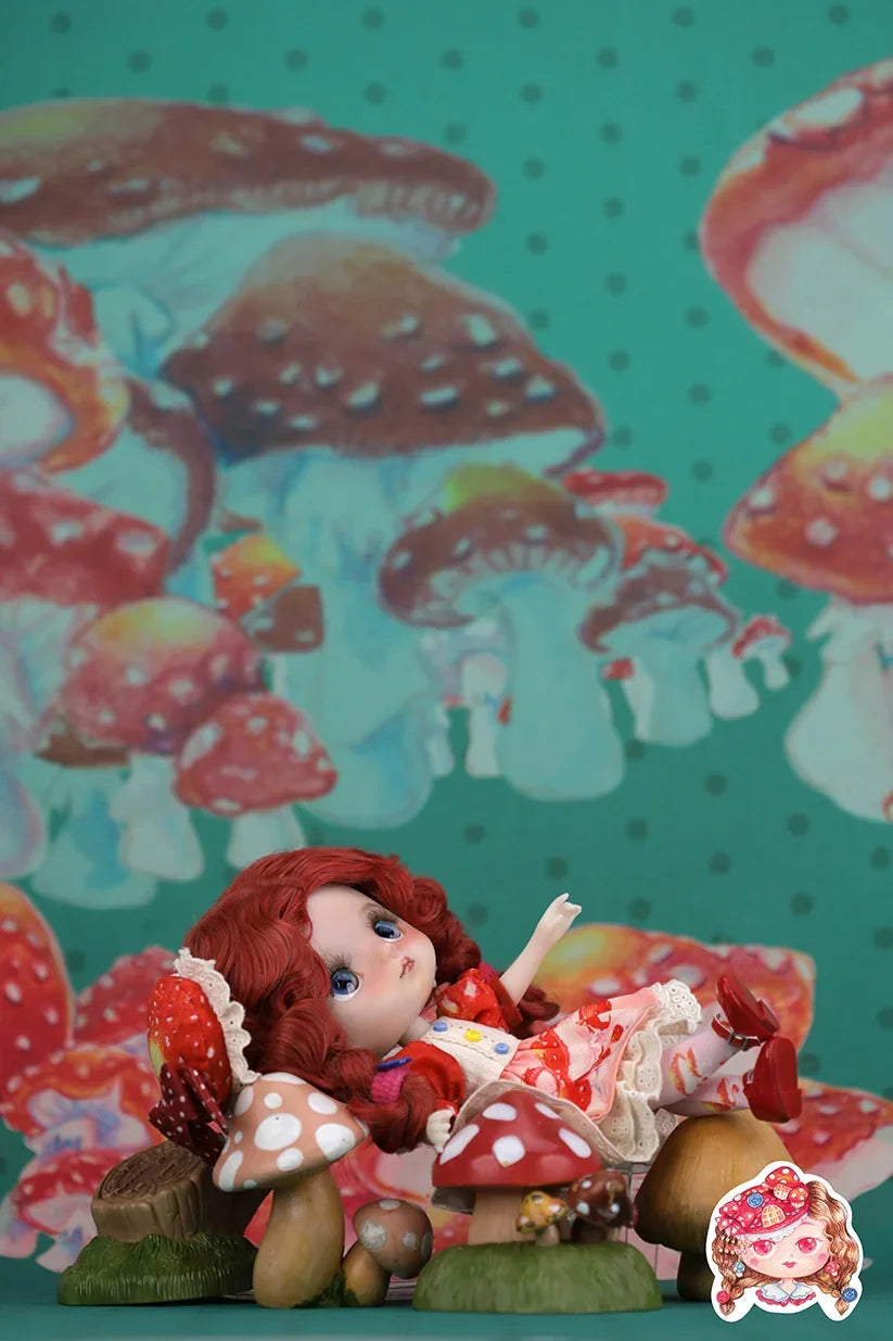 Mori Lolli doll with red hair sitting on mushrooms against a colorful mushroom-patterned background.
