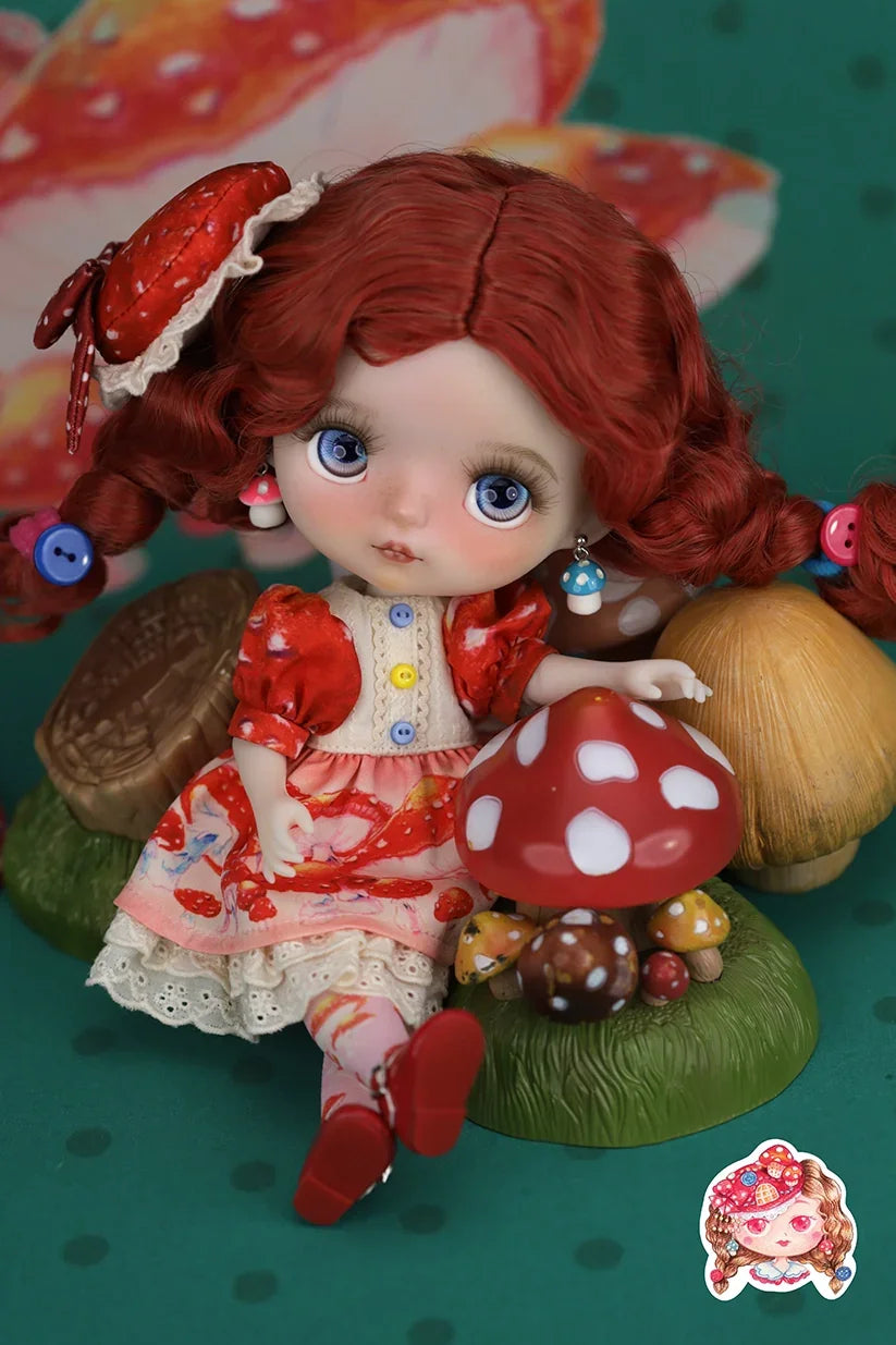 Mori Lolli Mushroom Fantasia Doll with red hair and outfit sitting on a mushroom with a colorful background