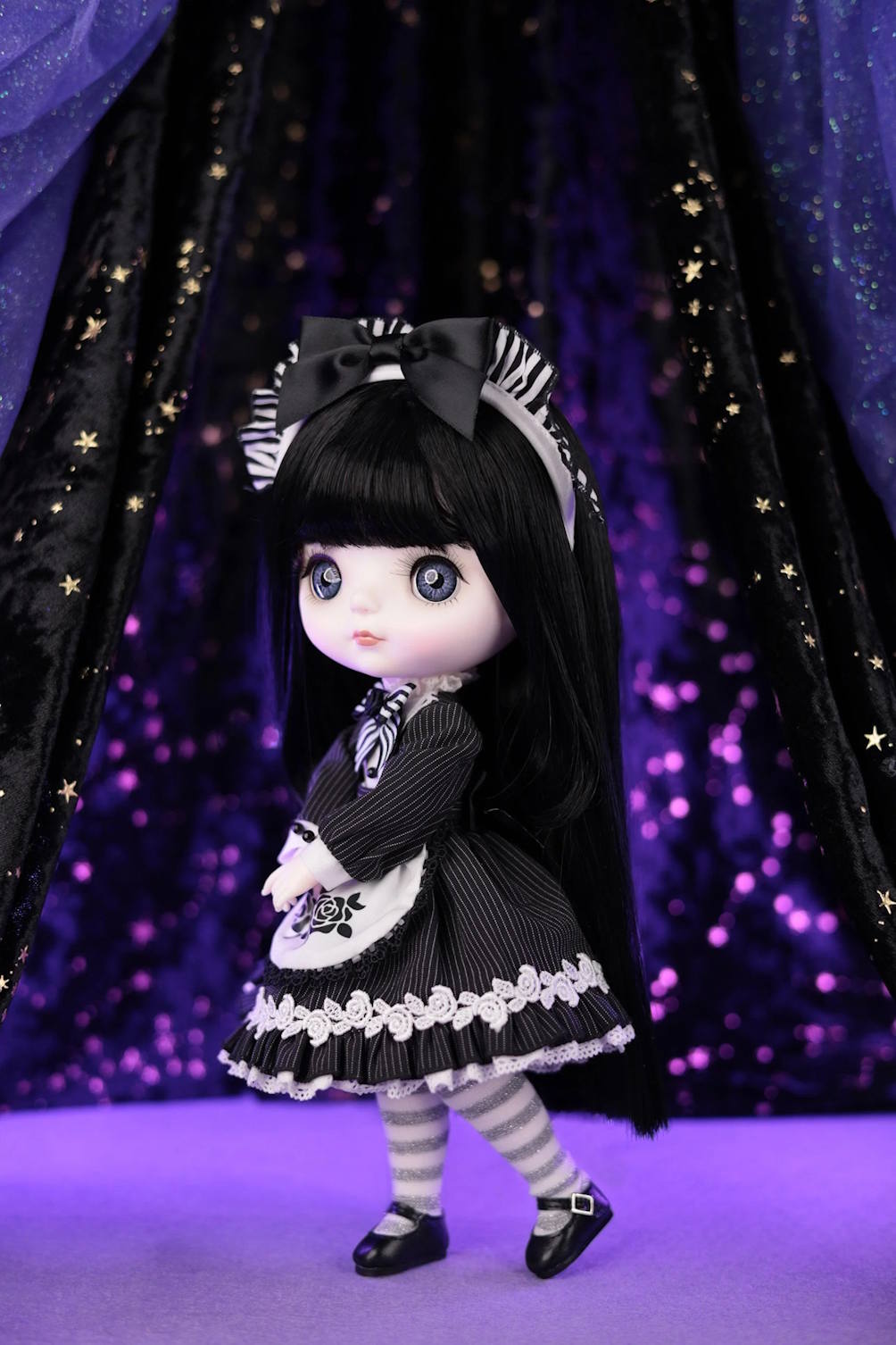 Mori Lolli Night Bloom collectible doll in a black gothic lolita dress and striped tights.