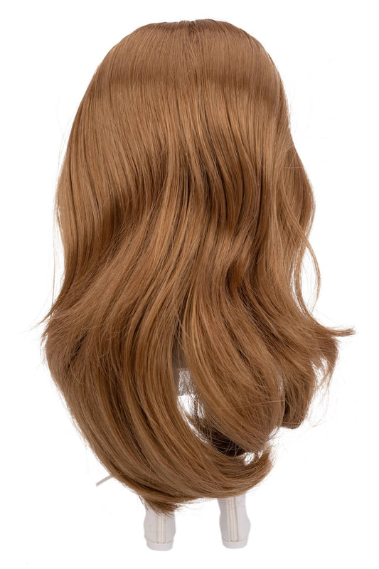 Brown wig on a doll head against a white background