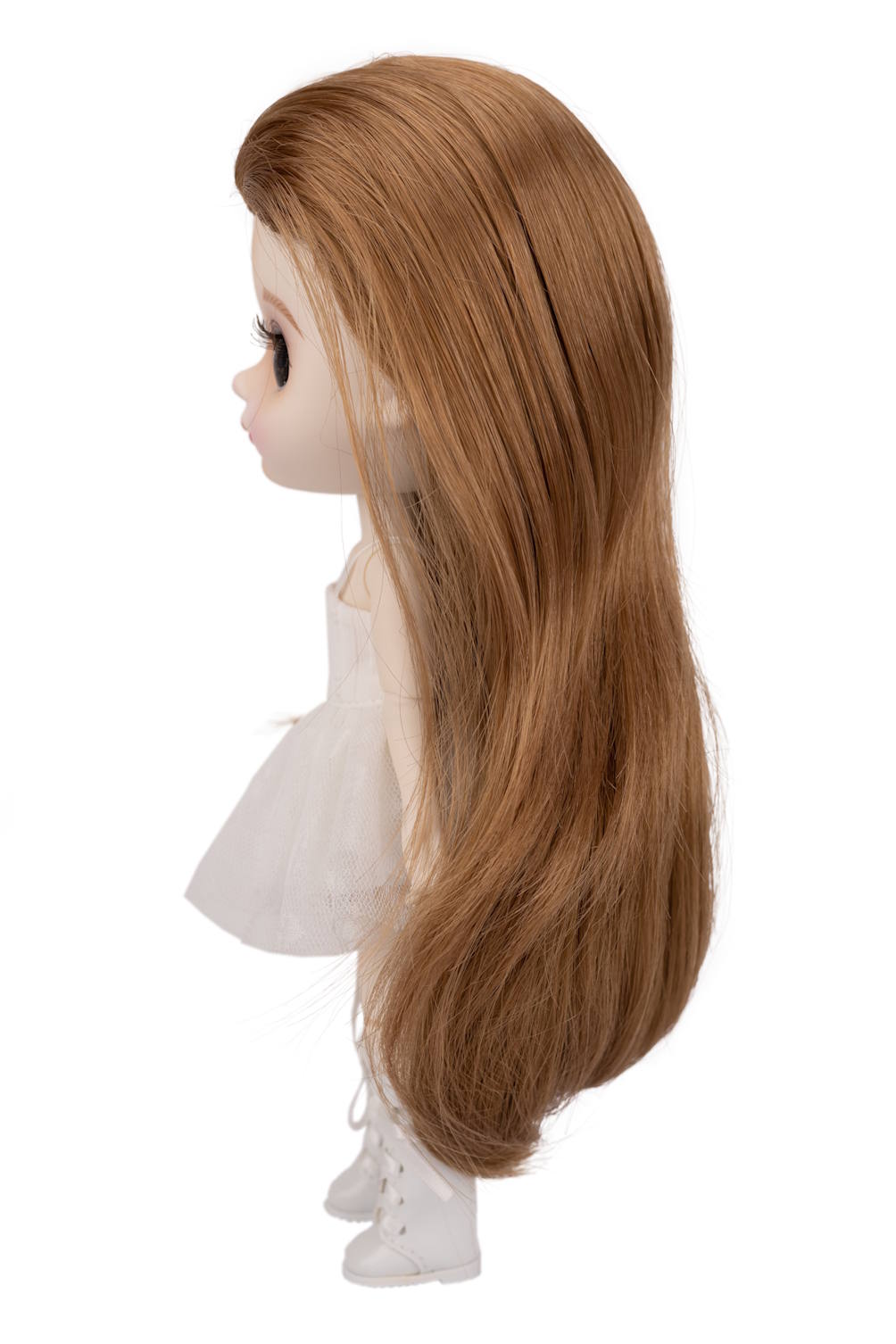 Doll head with long brown hair on a white background