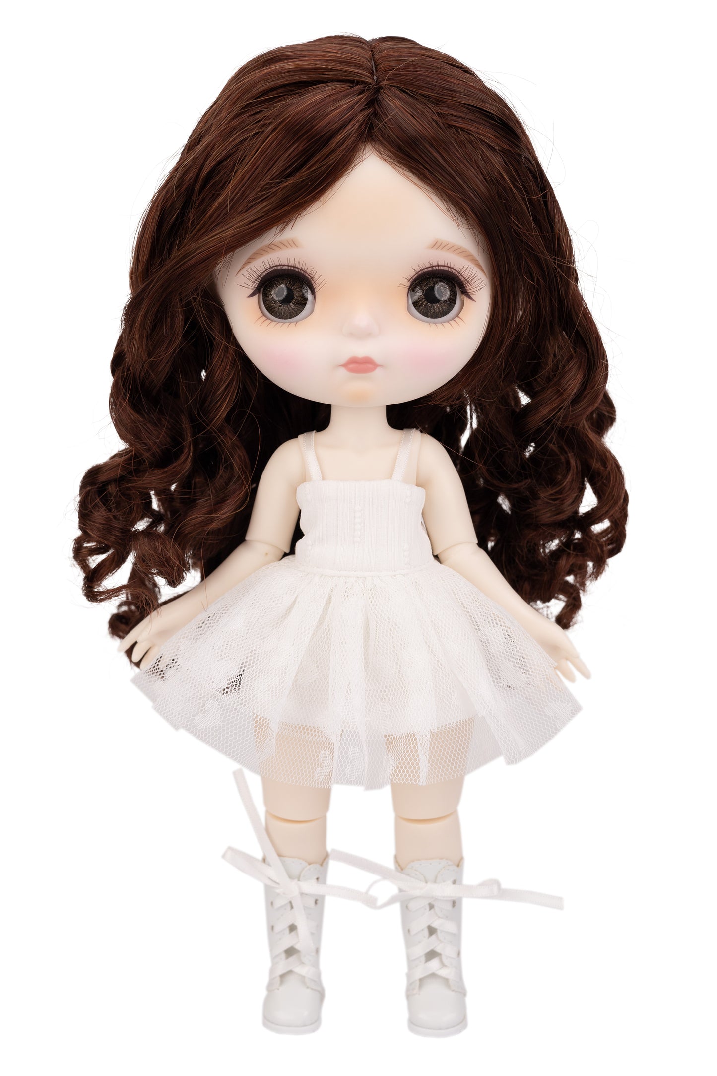 Doll with long brown hair wearing a white dress on a white background