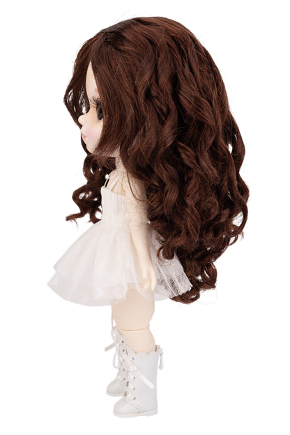 Brown wig on a doll with a white outfit against a white background