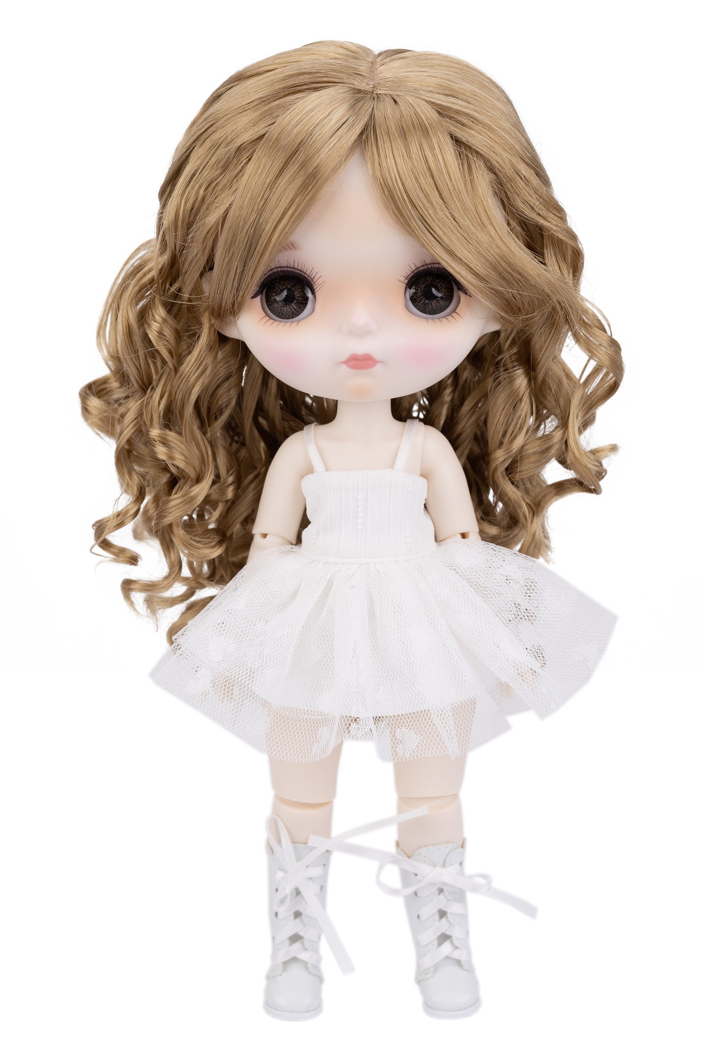 Doll with long blonde hair wearing a white dress on a white background