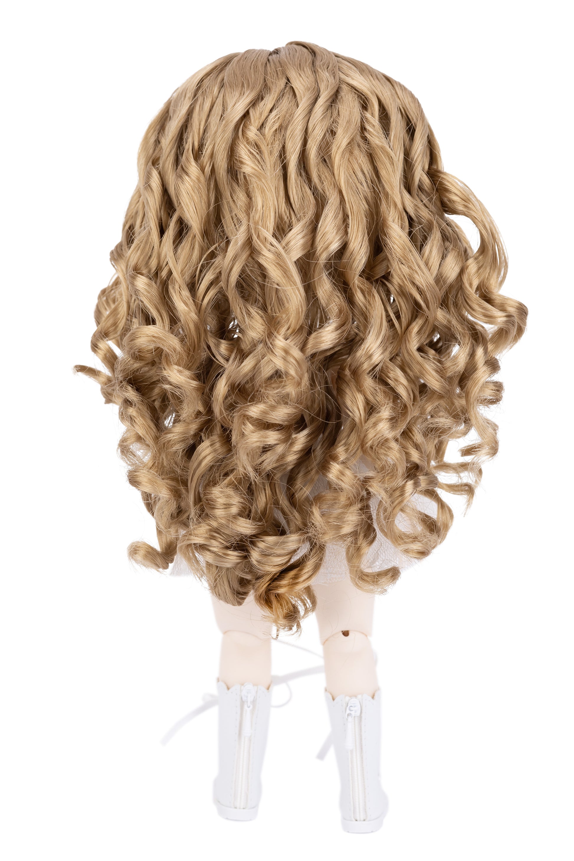 Blonde wavy wig on a doll head with white boots against a white background
