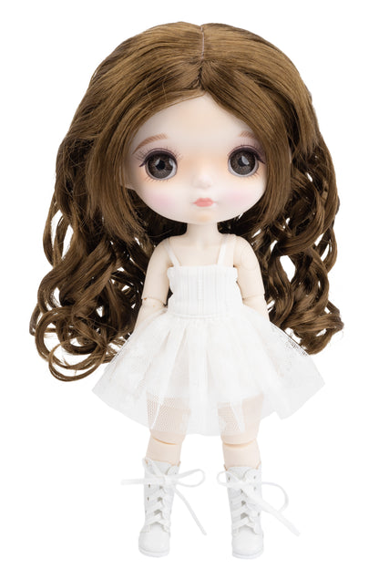 Doll with long brown hair wearing a white dress on a white background