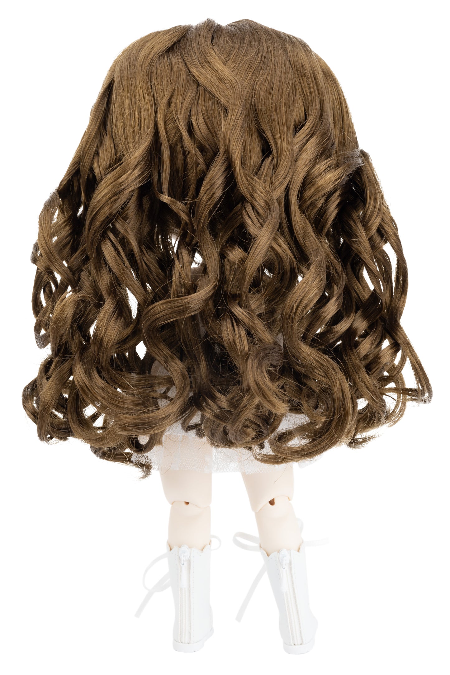 Brown wavy wig on a doll head against a white background