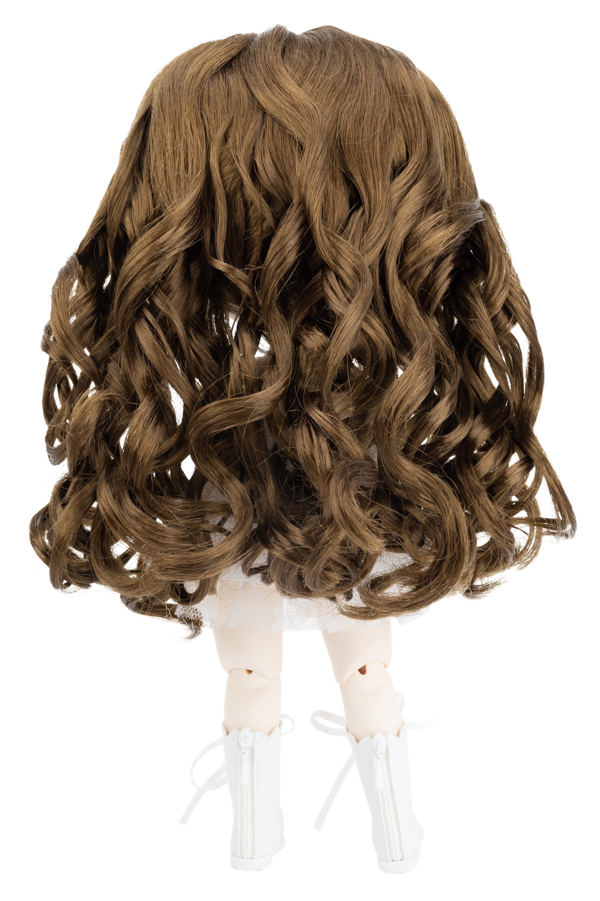 Brown wavy wig on a doll head against a white background