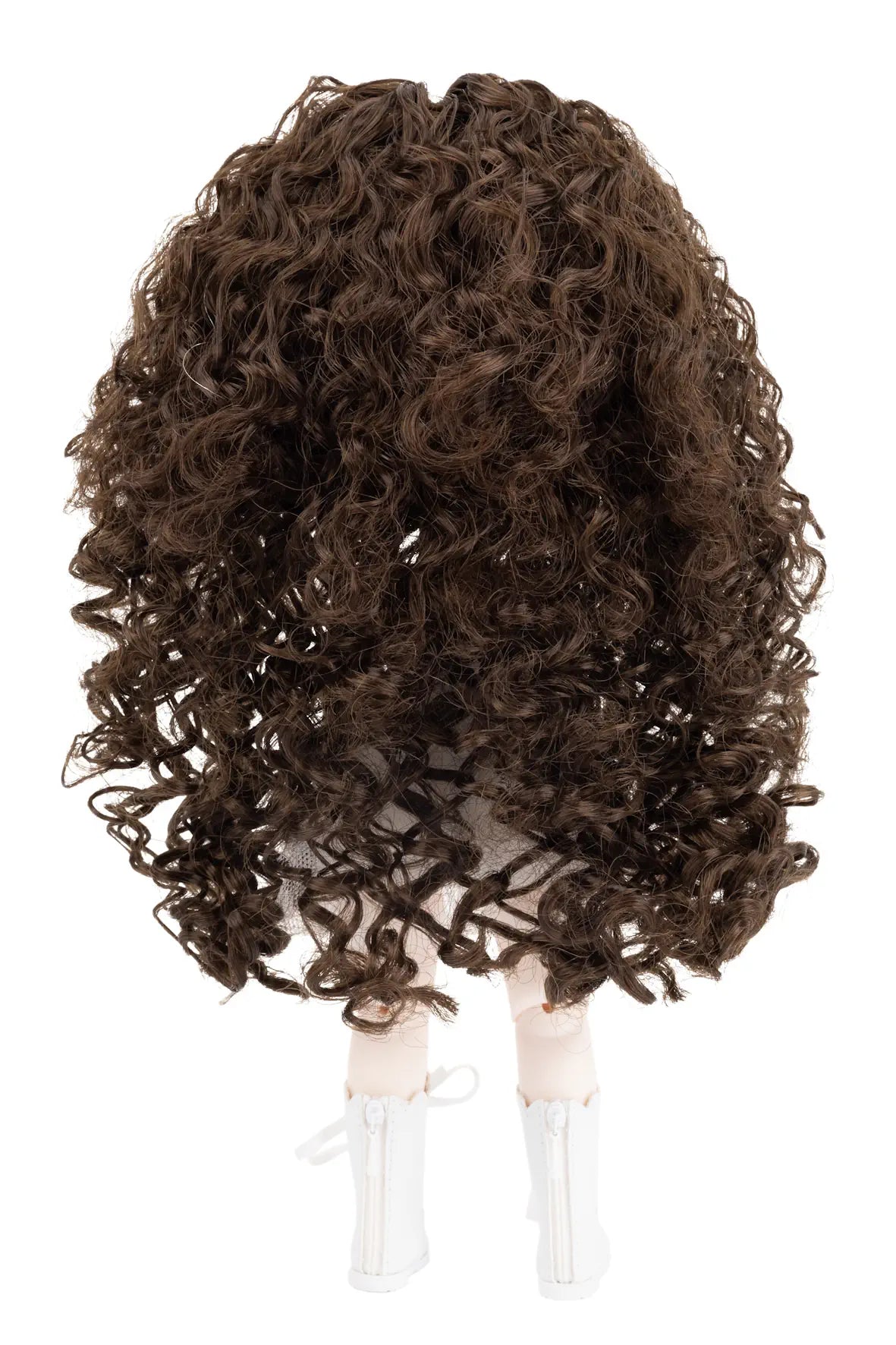 A dark brown curly wig displayed on a mannequin head with white shoes, isolated on a white background.