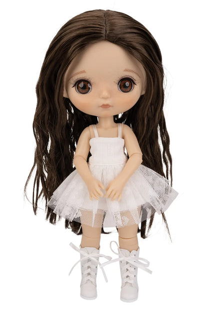 A doll with long dark brown wavy hair, large brown eyes, and a white sleeveless tutu dress with white lace-up shoes, shown against a plain white background.