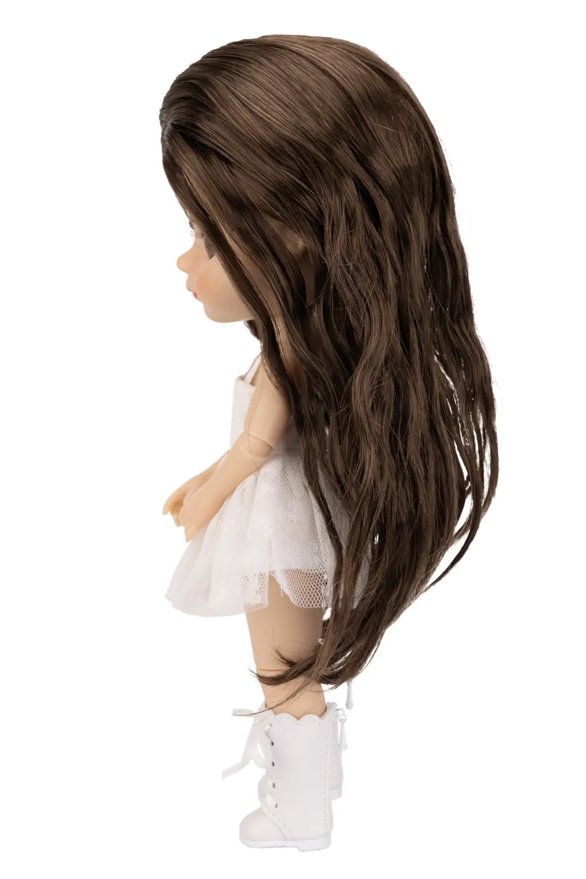 A doll shown in side profile with long, wavy brown hair, wearing a white dress and white lace-up boots, isolated on a white background.