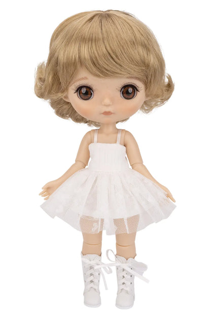 A doll with short blonde hair, large brown eyes, and a white sleeveless tutu dress with white lace-up shoes, shown against a plain white background.