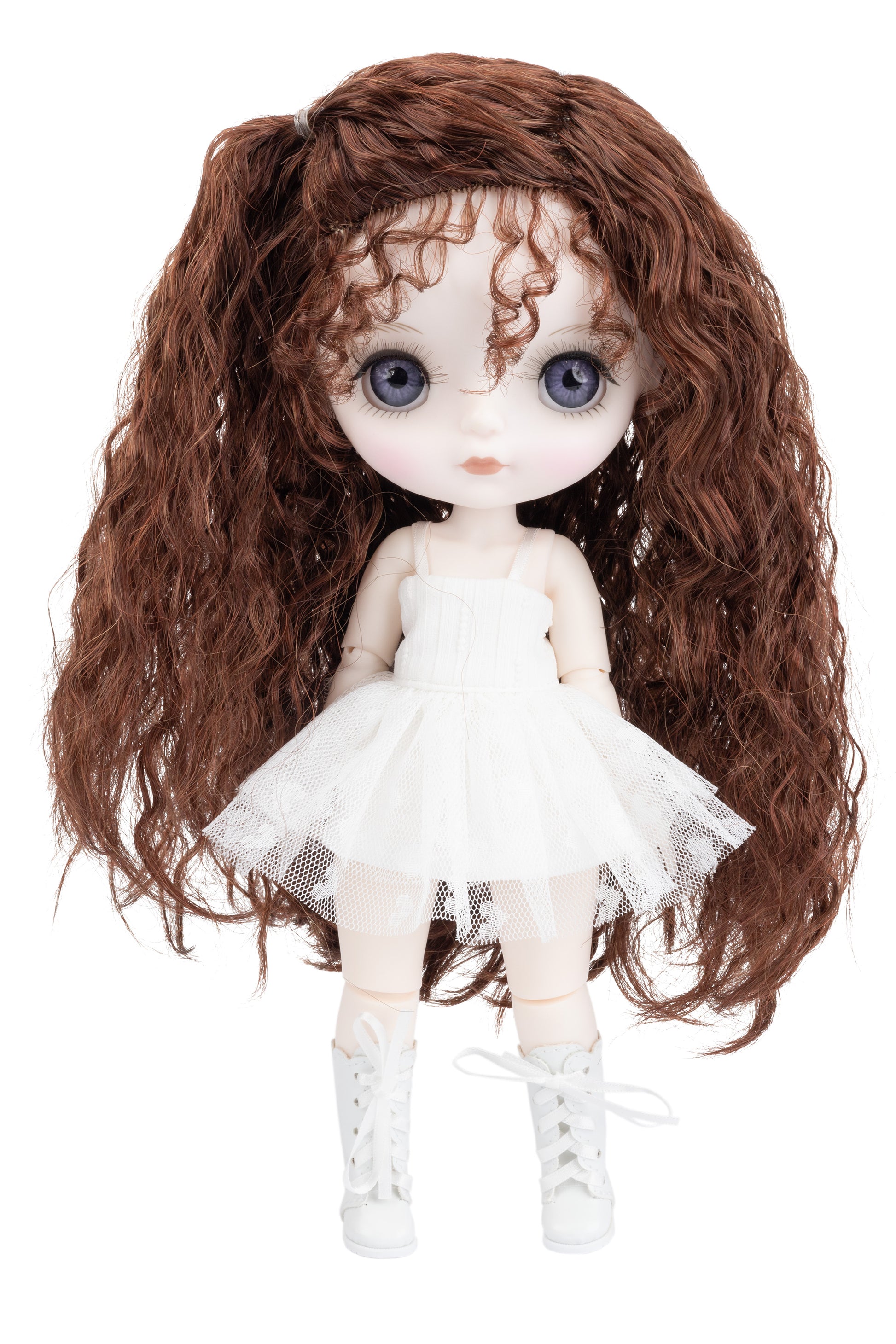 Doll with long brown hair and a white dress on a white background
