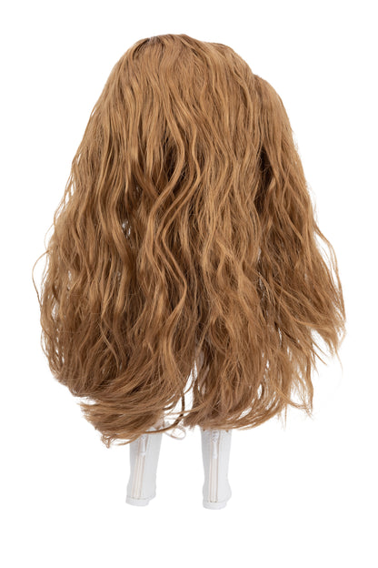 Brown wig on a doll head against a white background