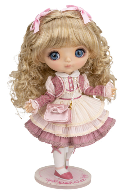 Candice doll with blonde hair and blue eyes wearing a pink and white outfit on a white background