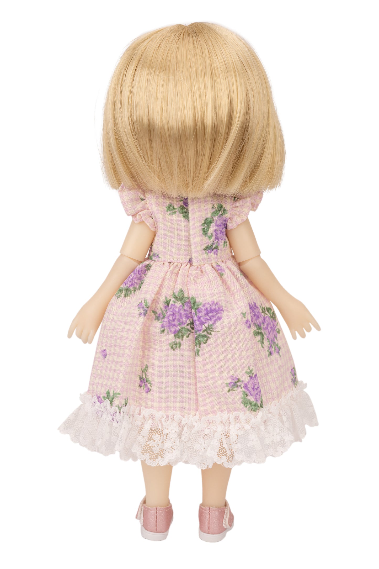 Doll wearing a pink floral dress on a white background