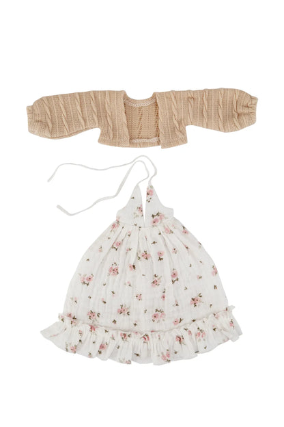 A two-piece baby outfit set on a white background, featuring a beige smocked cardigan and a white floral halter dress with a ruffled hem and tie strings.