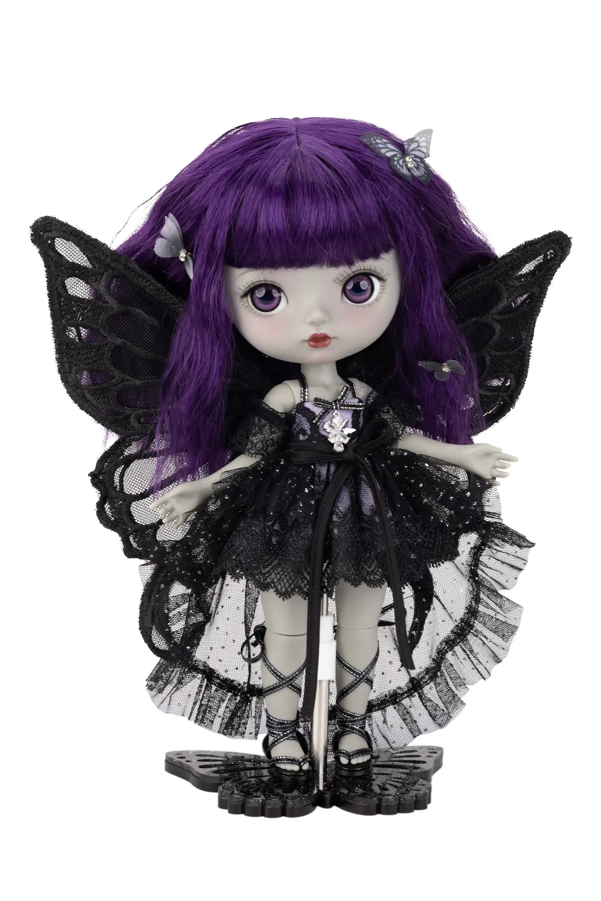 Gothic-style fairy doll with purple hair and black wings on a white background
