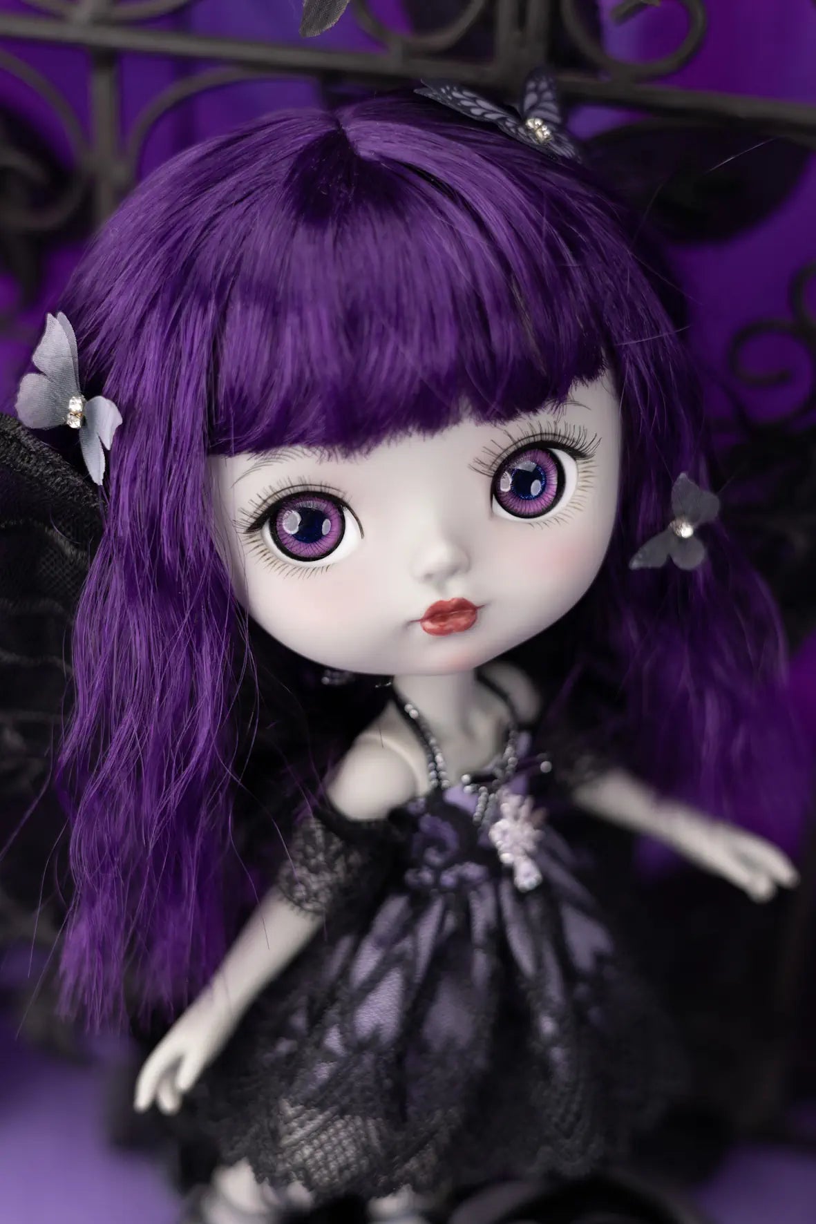 Mori Lolli Dark Fairy Doll with purple hair and a dark outfit on a purple background