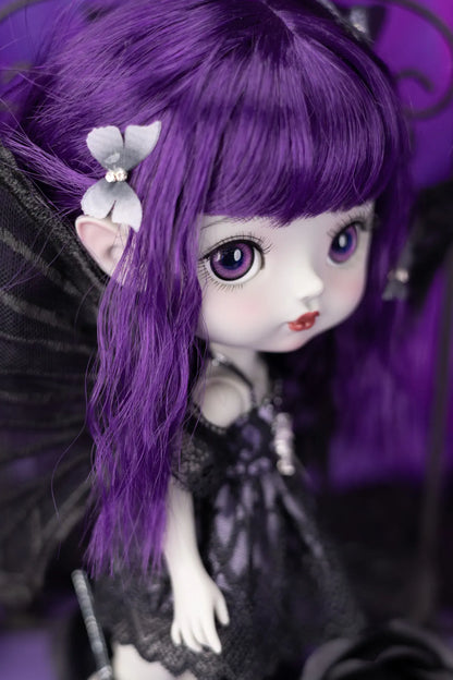 Gothic-style doll with purple hair and black dress against a dark background