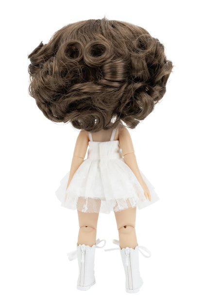 Doll with a large brown wig and white outfit on a white background