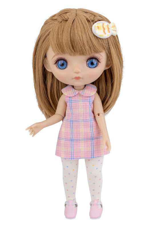 Doll with brown hair and blue eyes wearing a pink plaid dress on a white background