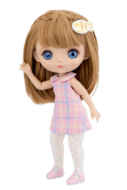 Doll with long brown hair and blue eyes wearing a pink checkered dress on a white background