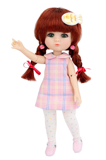 Doll with red hair in pigtails wearing a pink plaid dress on a white background