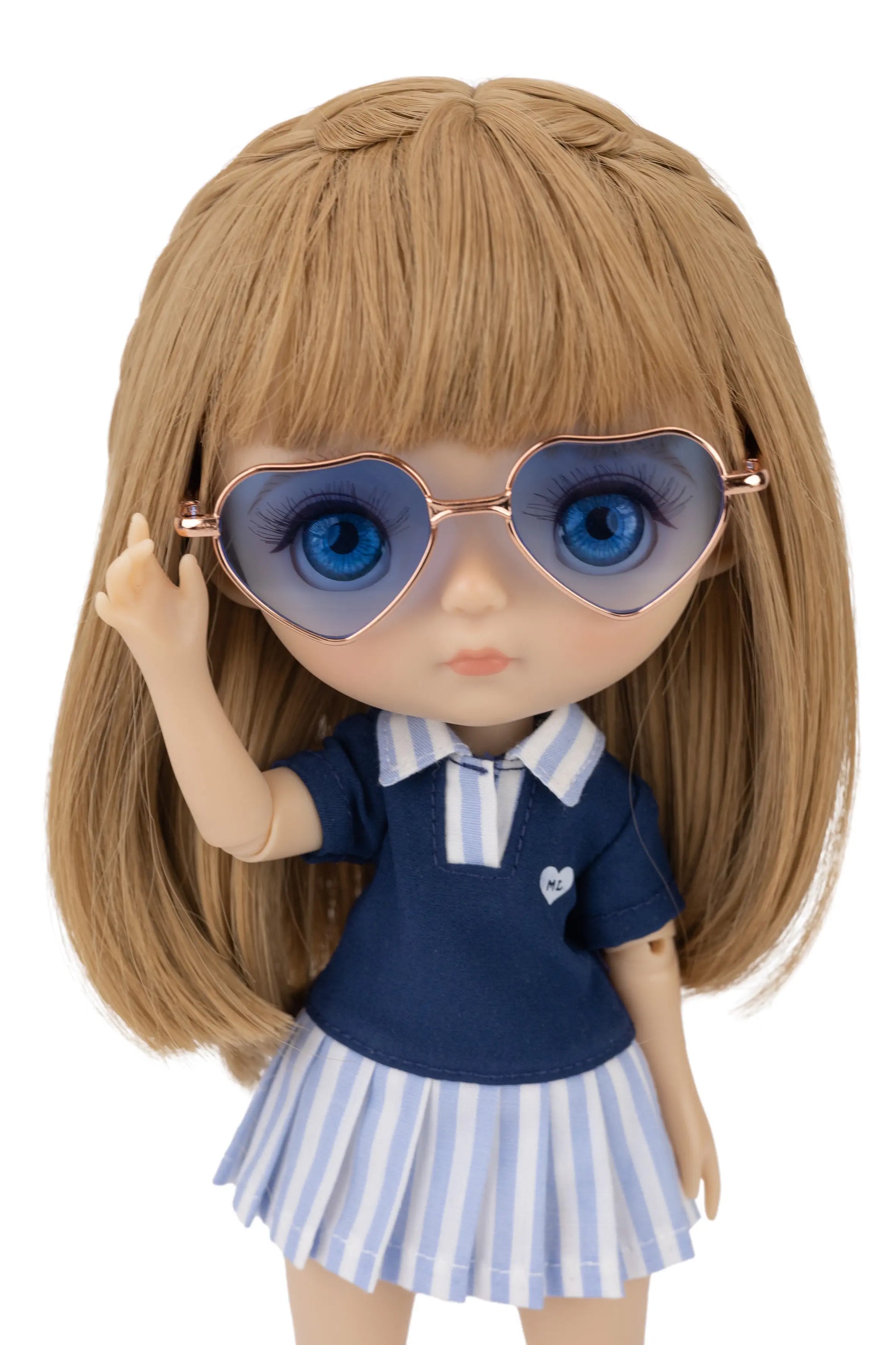 Doll wearing a navy blue shirt with a white collar and striped skirt, holding heart-shaped sunglasses with blue glasses.