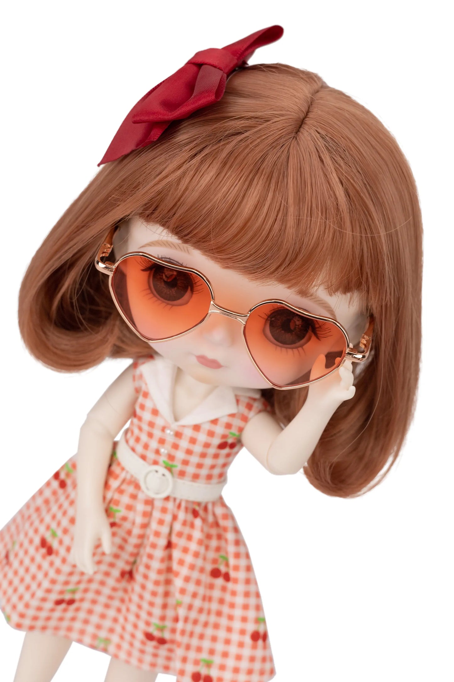 Doll with red checkered dress and red sunglasses on a white background
