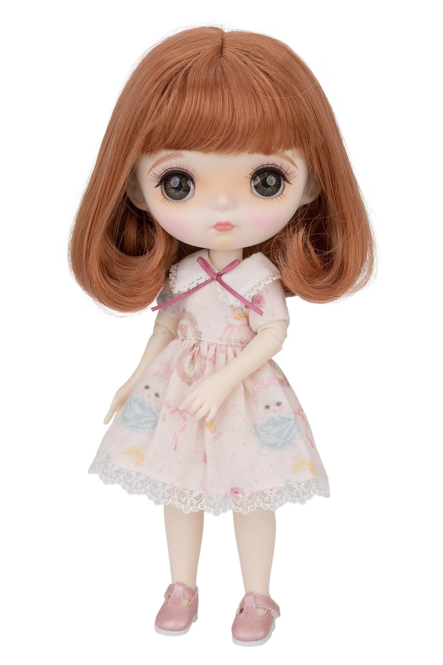Doll with brown hair and a pink dress on a white background