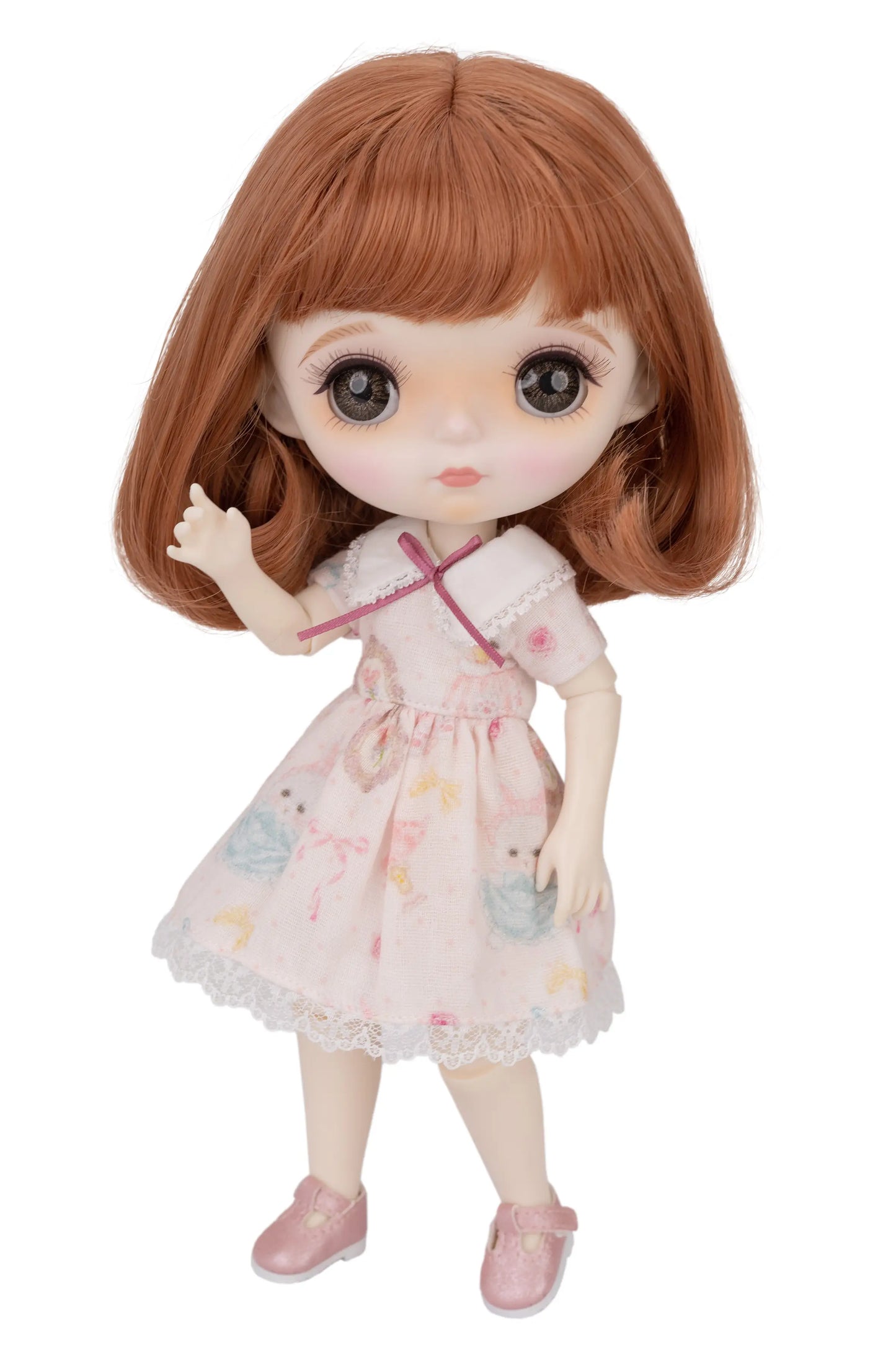 Doll with brown hair and a pink dress on a white background