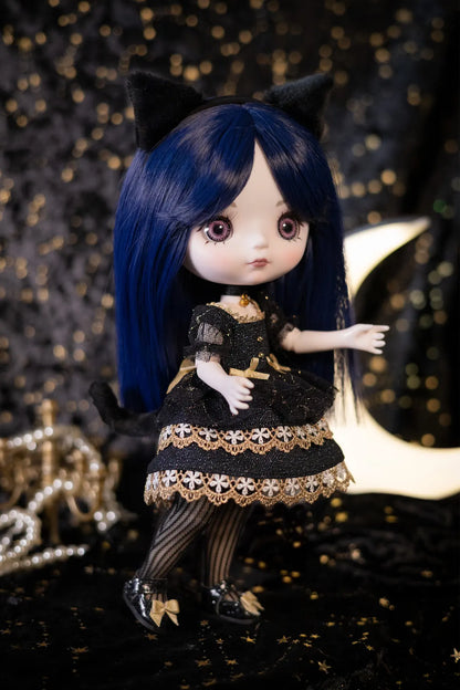 A doll with long dark blue hair, black cat ears, and a black dress with gold lace trim, posed against a dark backdrop with gold bokeh lights and a crescent moon.