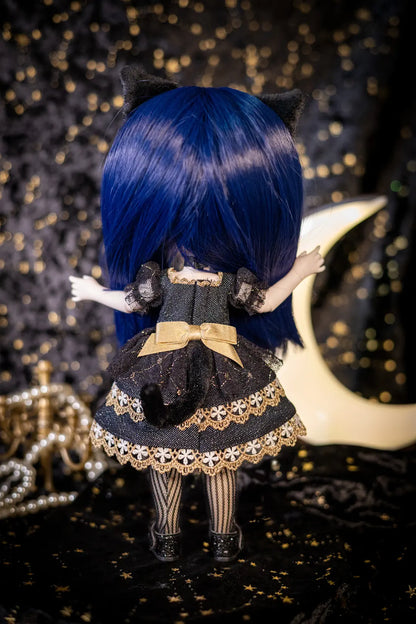 A doll viewed from behind wearing a black and gold gothic-style dress with a large blue wig and black cat ears, posed against a dark starry backdrop with a crescent moon and pearl strands.