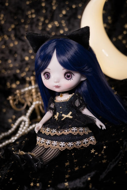 A doll with long dark blue hair, black cat ears, and a black dress with gold lace trim and star details, posed against a dark starry backdrop with a crescent moon and pearl strands.