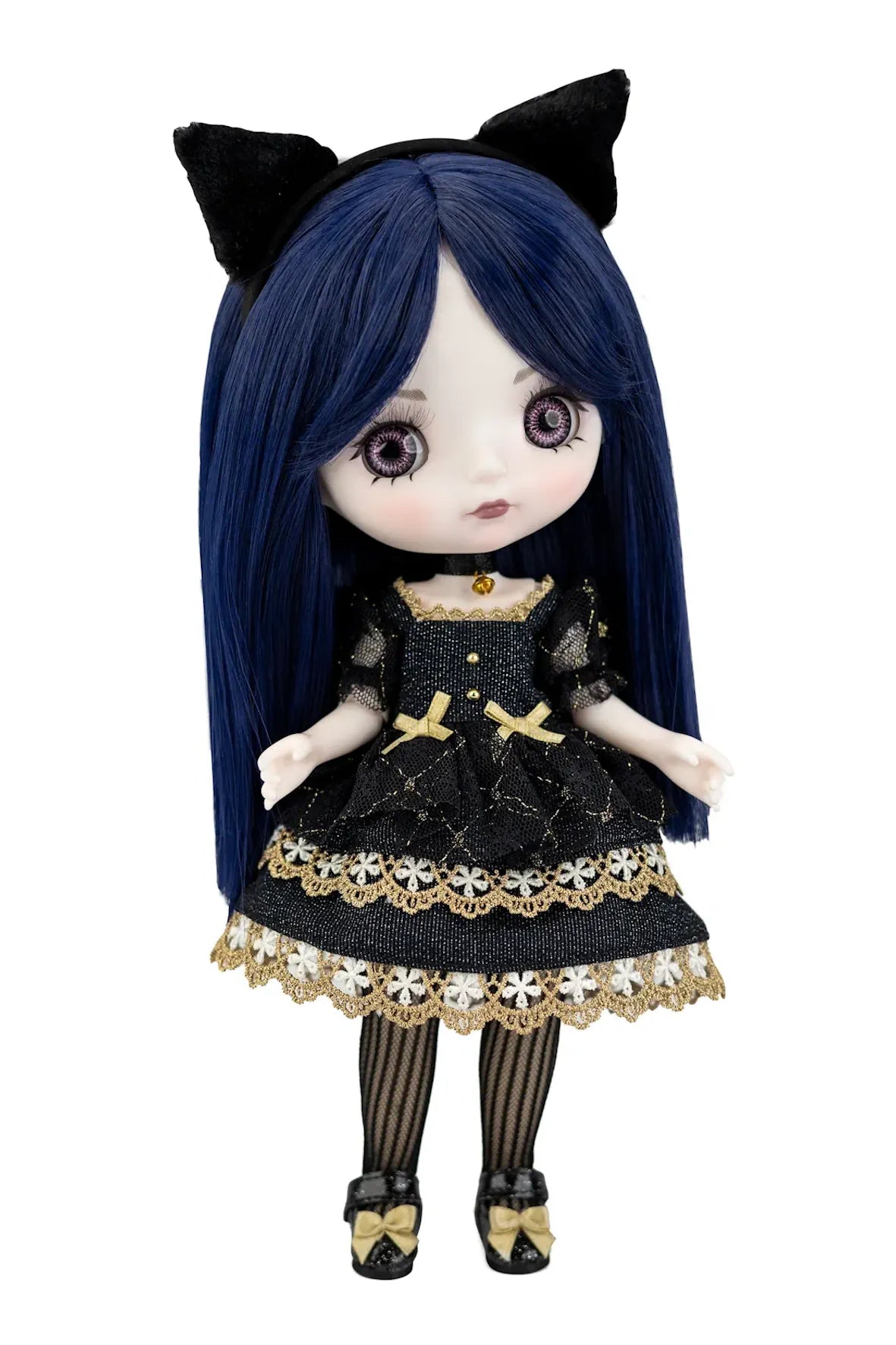 A doll with long dark blue hair, black cat ears, and a black dress with gold trim and lace details, standing against a plain white background.