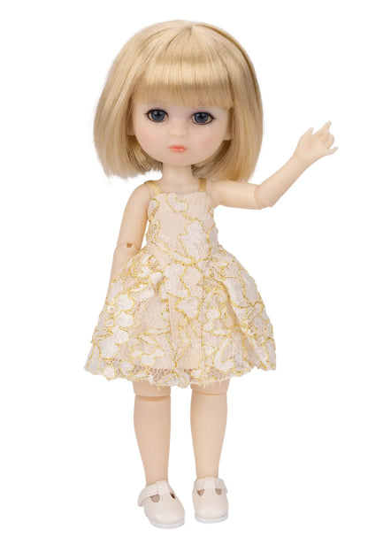 A blonde doll with blue eyes wearing a cream and gold floral lace dress with white shoes, standing against a plain white background.