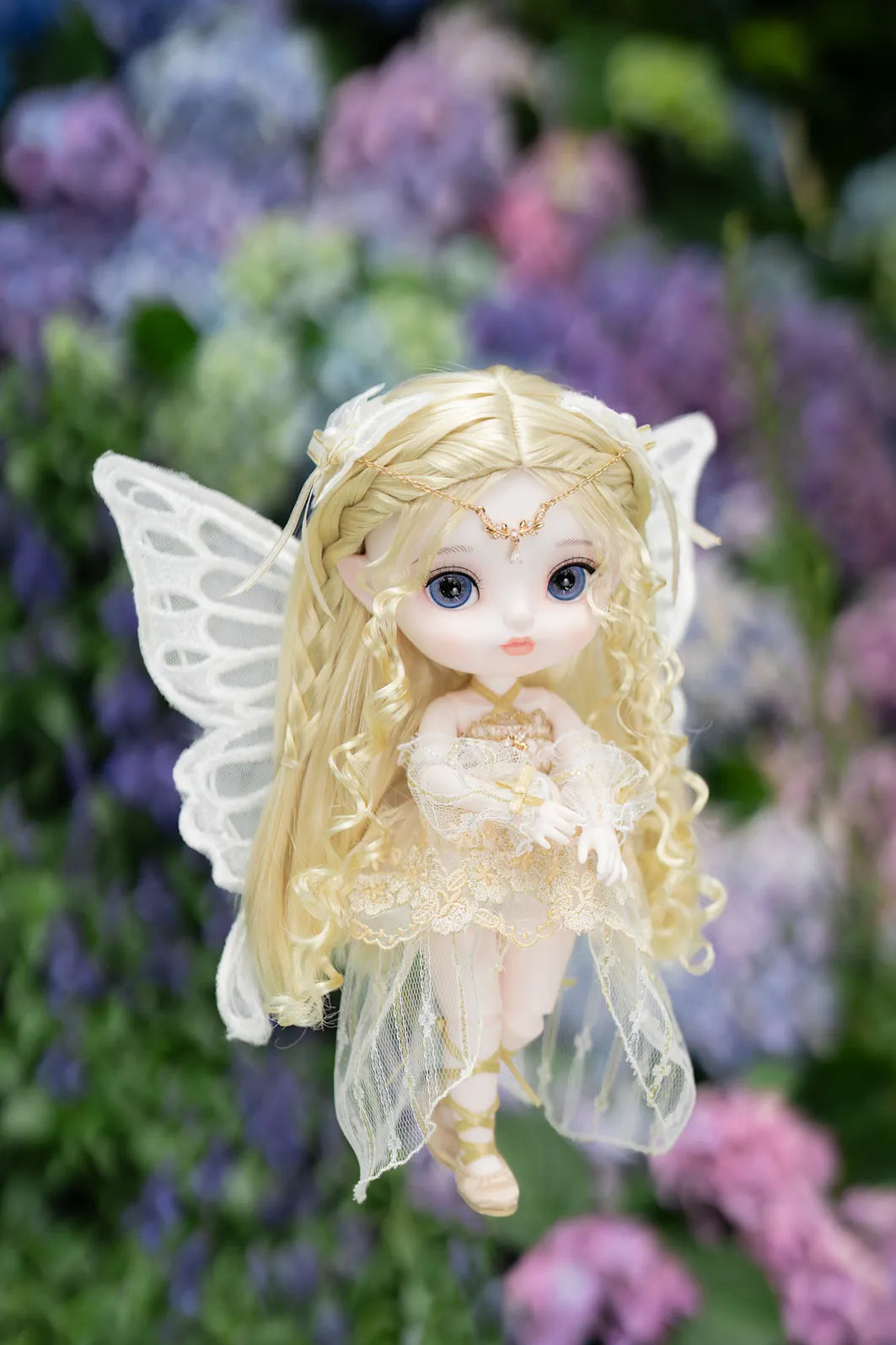 Fairy doll with wings in a garden setting